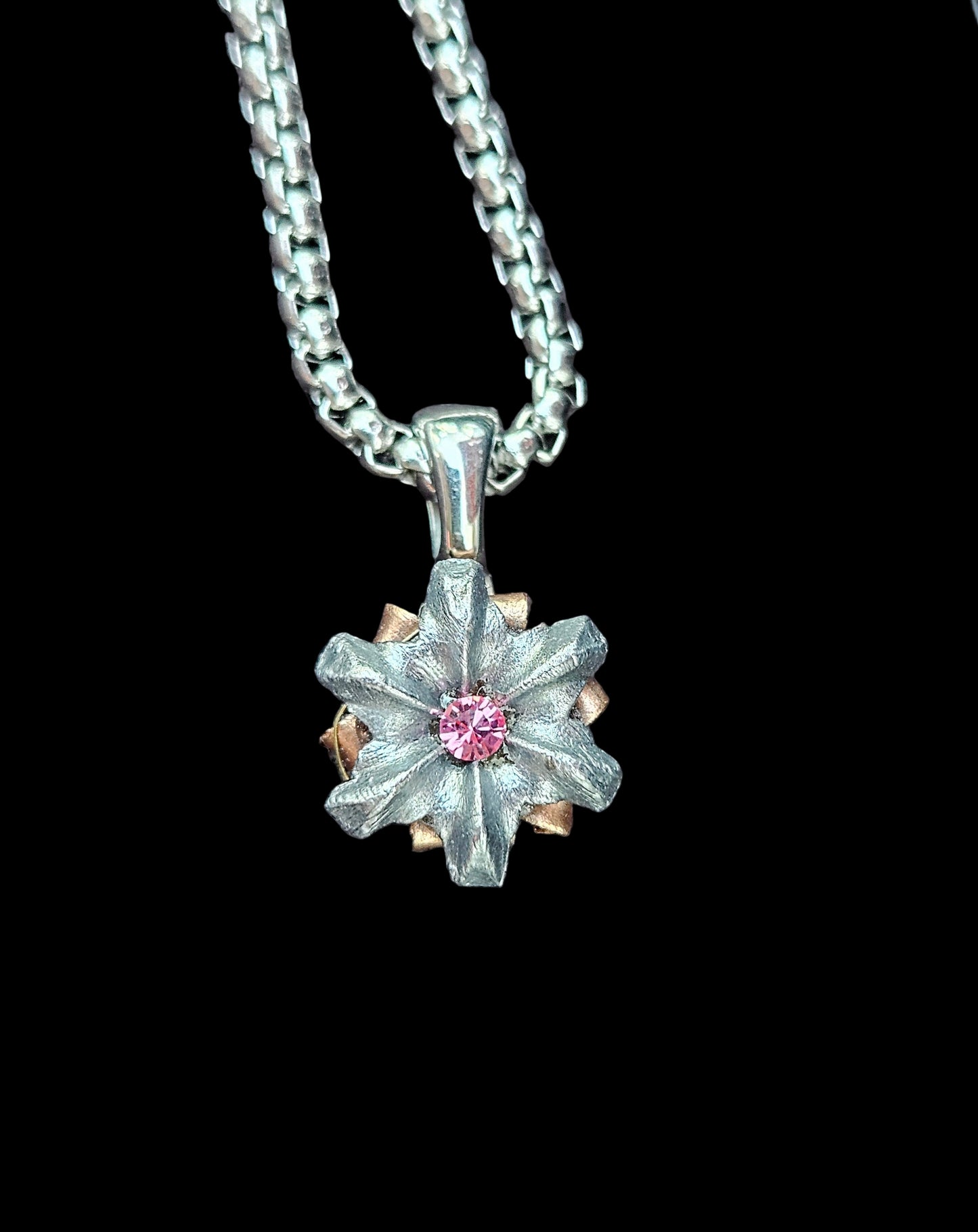 Flower shaped silver pendant with light pink crystal center