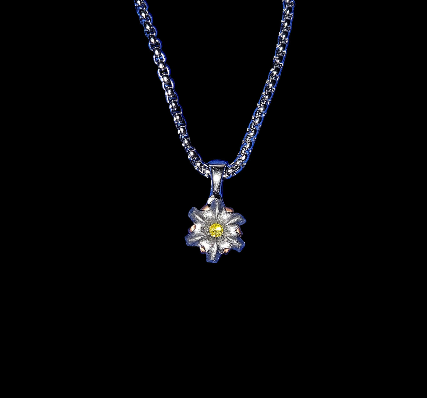 Silver necklace with a flower pendant on a black background
