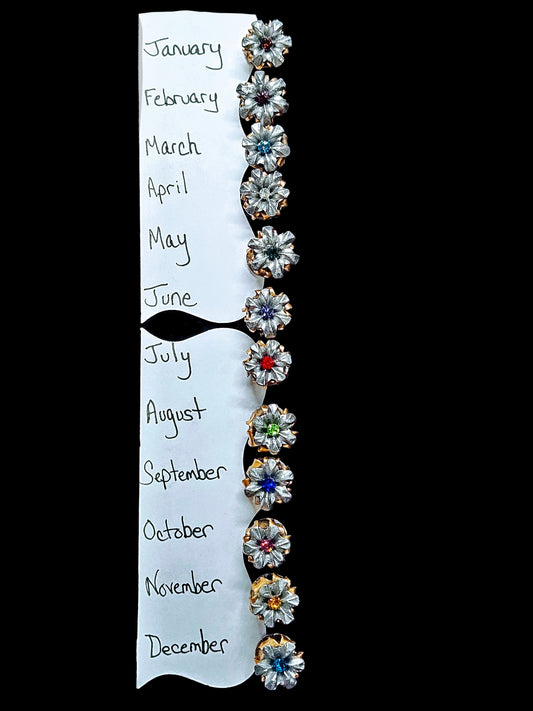 Image shows 12 Blooming Bullet Pins with corresponding birthstone colored crystals in the center.