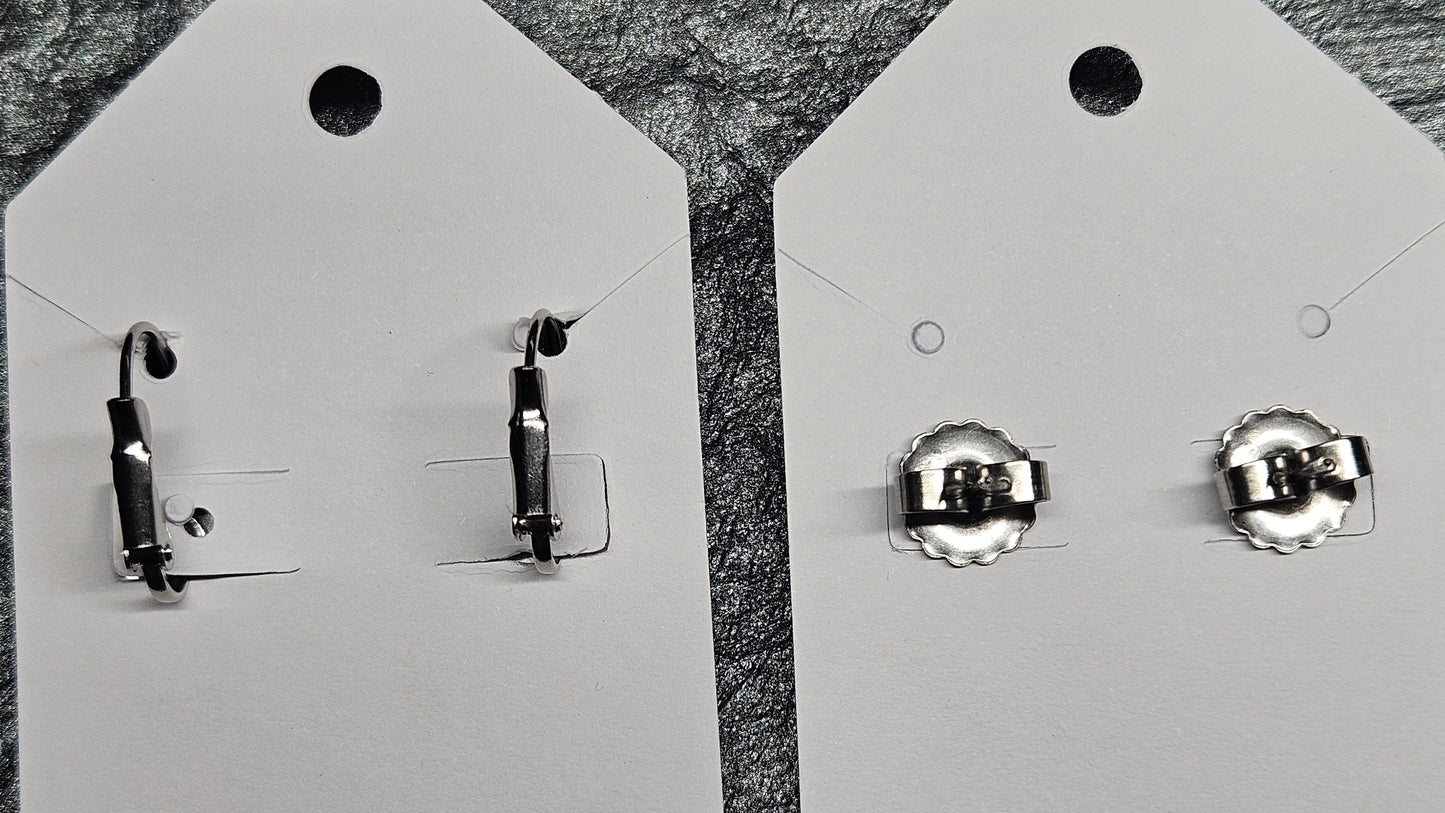 Two Pairs of silver earring backs on white earring cards