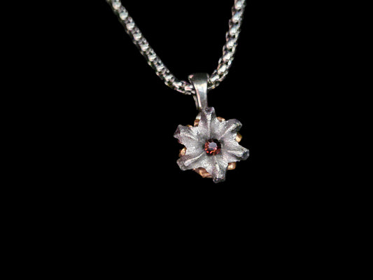 Silver pendant necklace on a black background