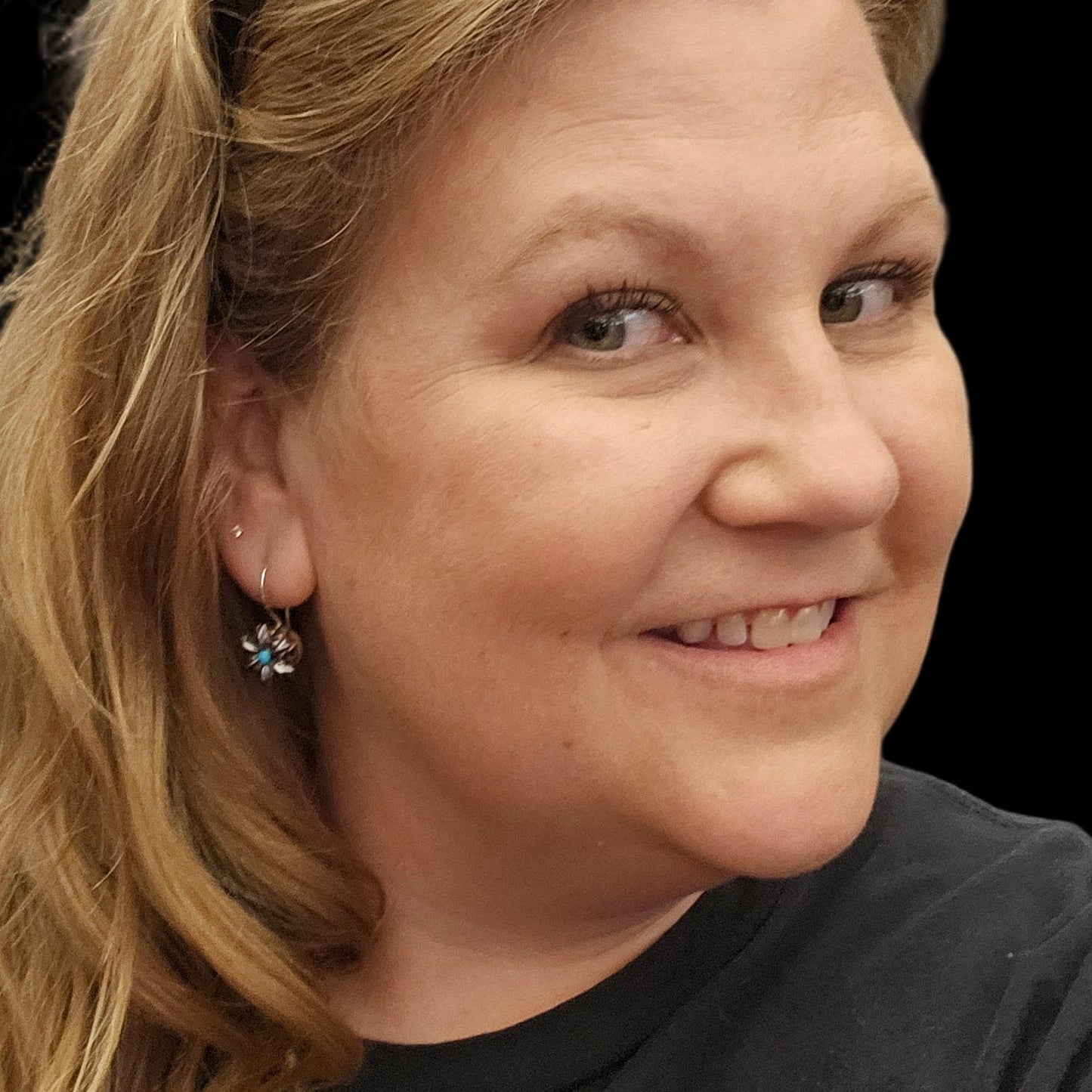 Woman with blonde hair wearing Blooming Bullet Earrings on a black background