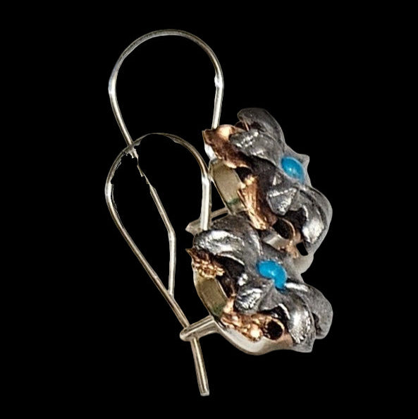 Silver earrings turquoise blue stones on a black background